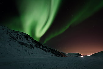 Vibrant Green Aurora Borealis Over Snowy Mountain Landscape