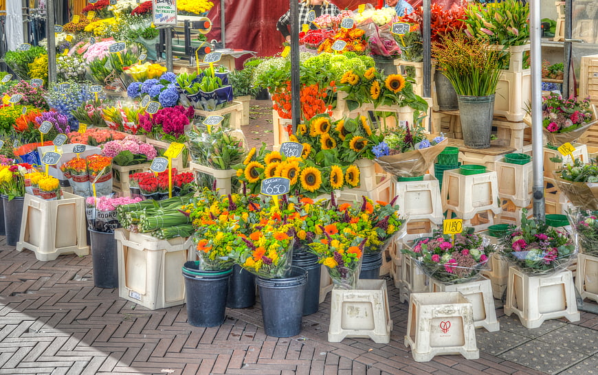 Colorful flower market stall with sunflowers and bouquets