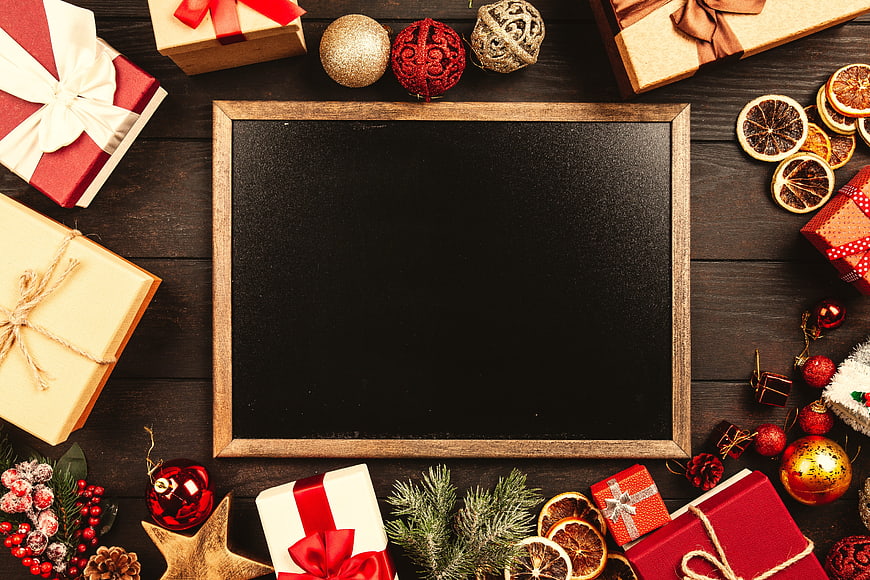 Christmas Gift Boxes And Ornaments Surrounding Black Chalkboard Frame
