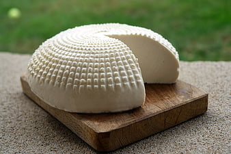Fresh White Goat Cheese Wedge on Wooden Board