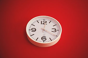 White Wall Clock on Vibrant Red Background