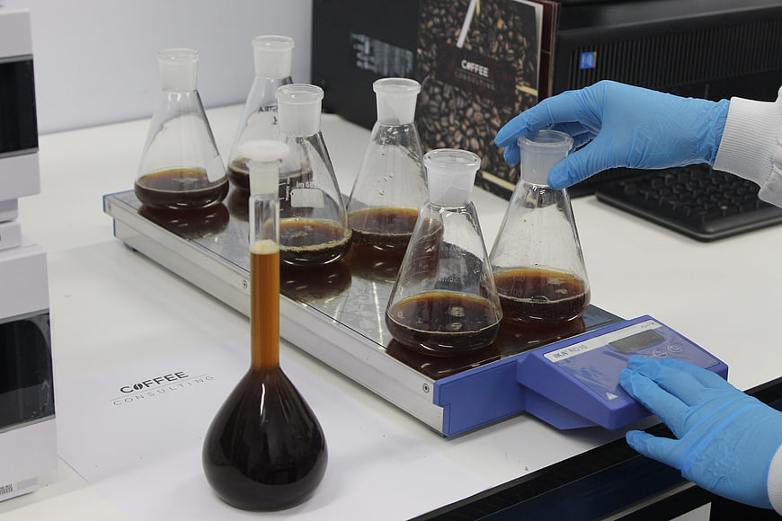 Coffee quality analysis in laboratory with flasks and scale