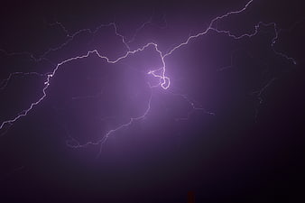 Dramatic Purple Lightning Strike in Dark Night Sky