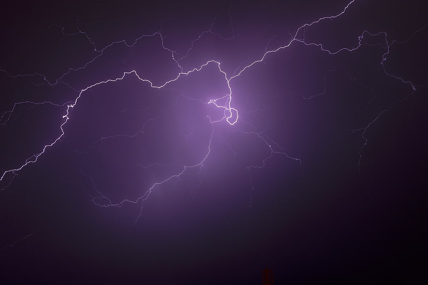Dramatic Purple Lightning Strike in Dark Night Sky