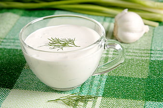 Glass Cup of Sour Cream Sauce with Dill and Garlic on Green Checkered Cloth
