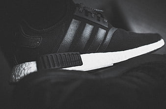 Black and white close-up of black sneaker with white sole