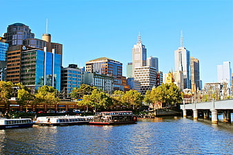 Melbourne CBD Skyline View From Yarra River With Boats And Bridge