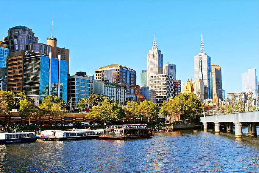 Melbourne CBD Skyline View From Yarra River With Boats And Bridge