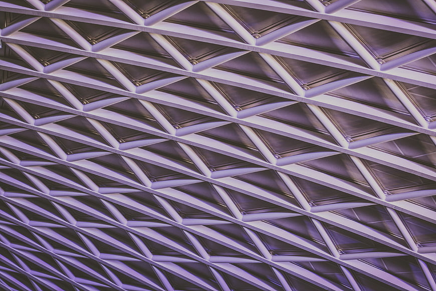 Abstract Geometric Ceiling Pattern with Purple Lighting