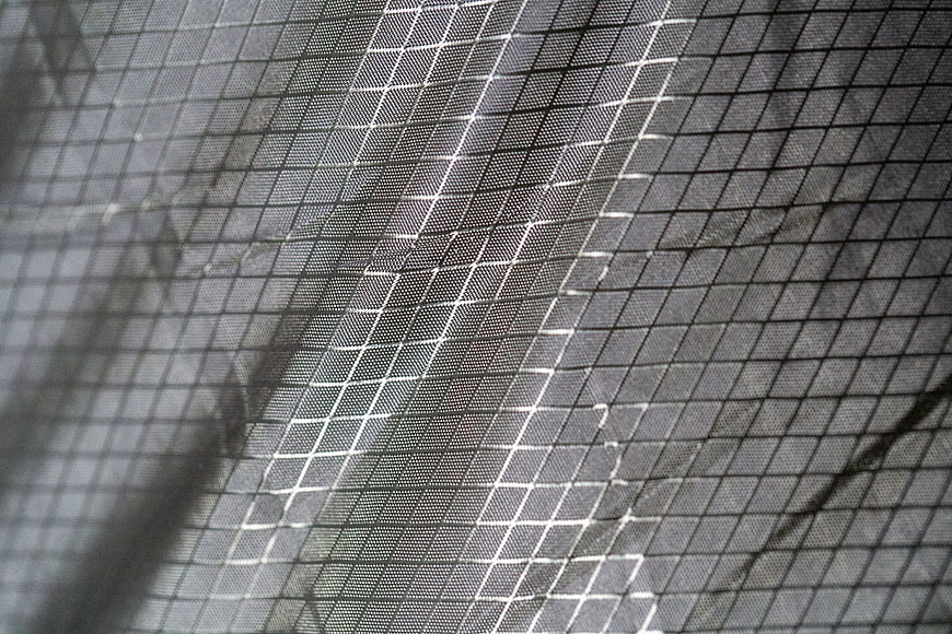 Close-up of black mesh fabric texture with grid pattern