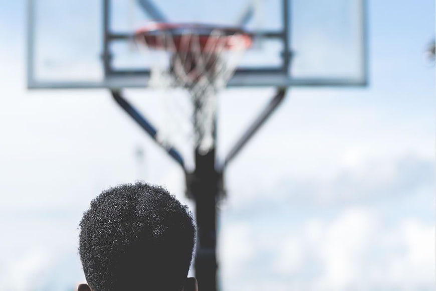 Back View of Man Looking at Basketball Hoop