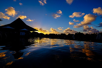 Sunset Reflection on Infinity Pool with Silhouette