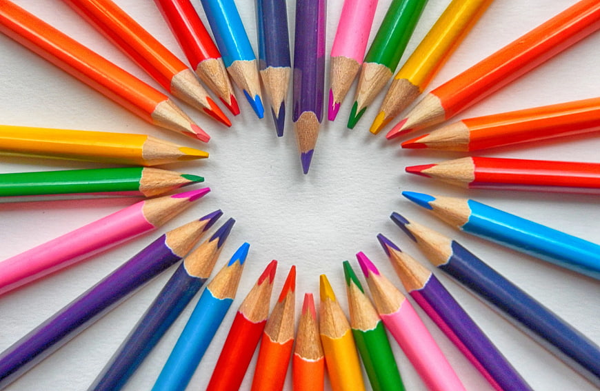 Colorful Pencils Arranged in a Circle on White Background