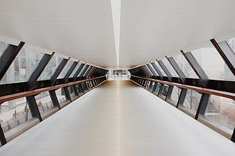 Modern architectural hallway with skylights and wooden railings