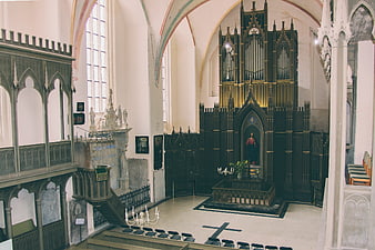 Gothic Church Interior with Dark Wooden Altar and Organ
