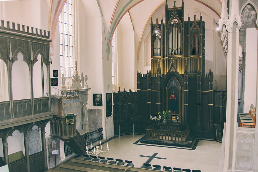 Gothic Church Interior with Dark Wooden Altar and Organ