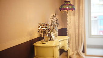 Elegant cream console table with silver decor and lamps