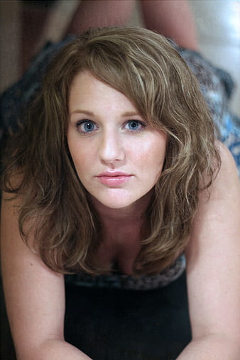 Close-up portrait of a young woman with blue eyes and wavy hair