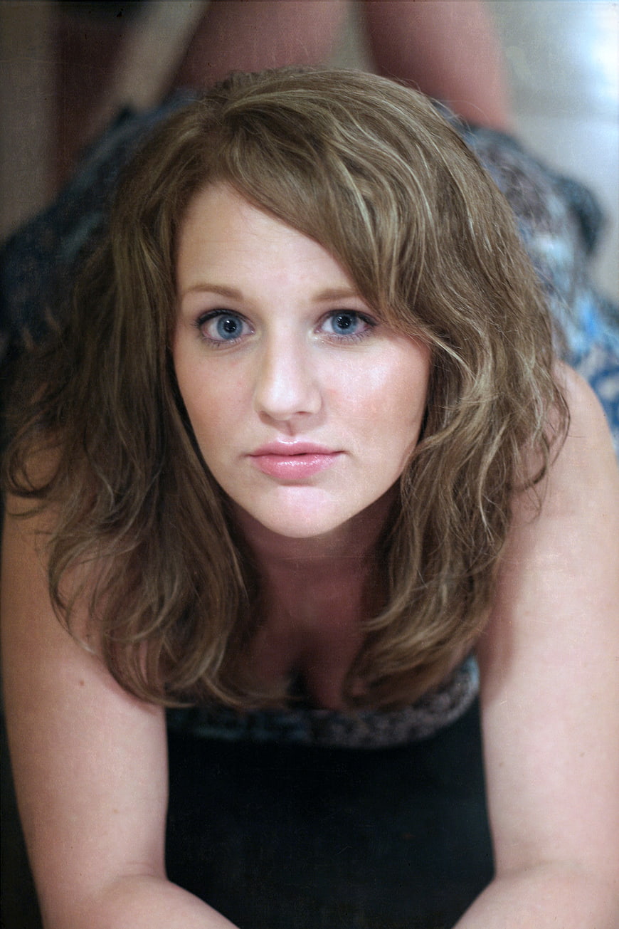 Close-up portrait of a young woman with blue eyes and wavy hair