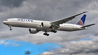 United Airlines Boeing 777 Landing Against Cloudy Sky