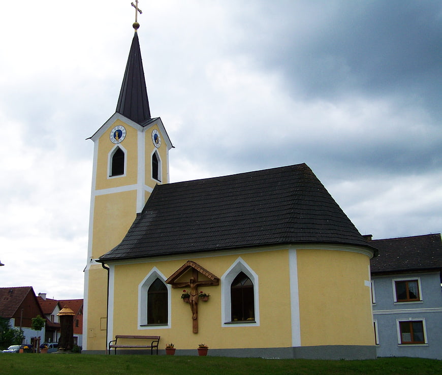 Yellow Baroque Church with Spire and Crucifix