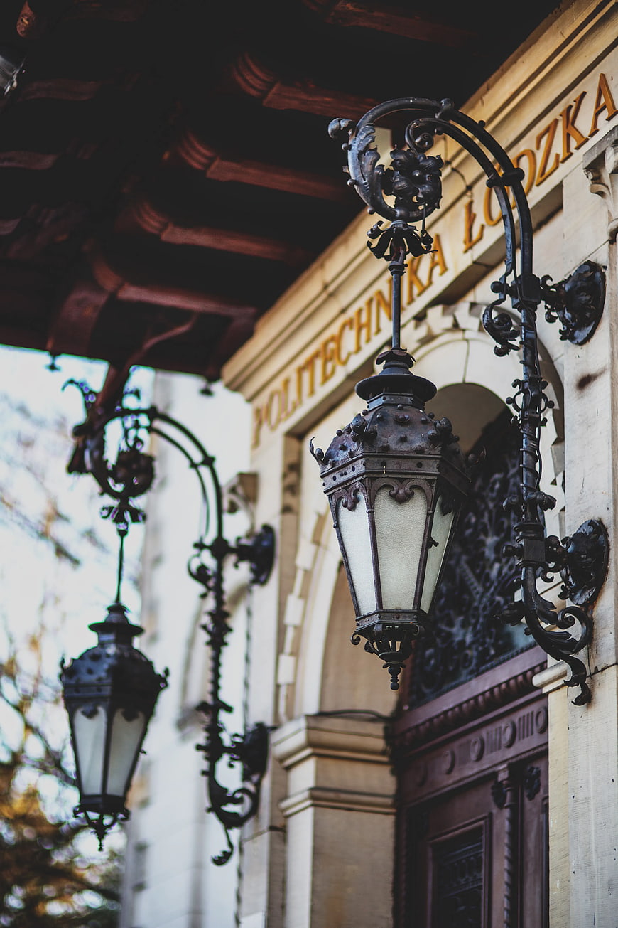 Vintage ornate lantern on historic university building facade