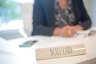 Boss Lady Nameplate on Office Desk with Woman Writing