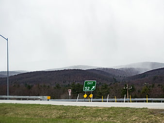 Highway Exit 52 Sign with Misty Mountains
