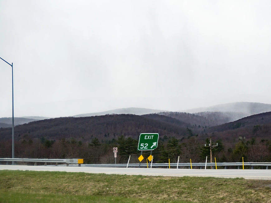 Highway Exit 52 Sign with Misty Mountains
