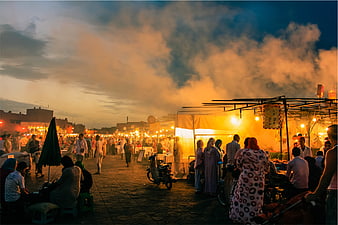Busy Night Market Scene with Steam and Warm Lights