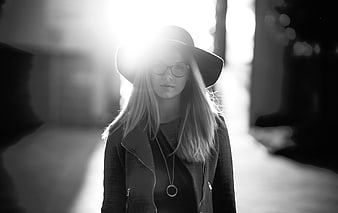 Stylish Woman in Hat and Glasses with Backlight