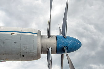 Close-up of vintage propeller airplane engine against cloudy sky