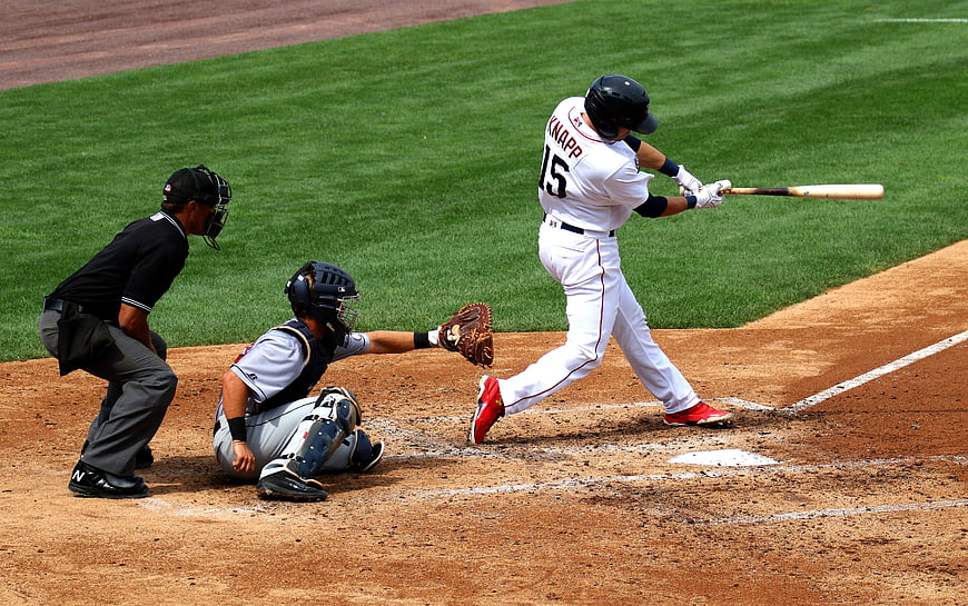 Baseball Batter Swinging at Home Plate with Catcher and Umpire