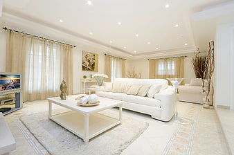 Bright white living room interior with beige curtains and modern furniture