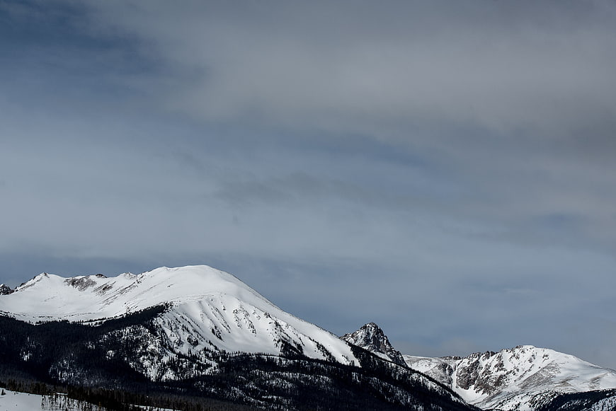 Snow-Capped Mountain Peaks Under Overcast Winter Sky