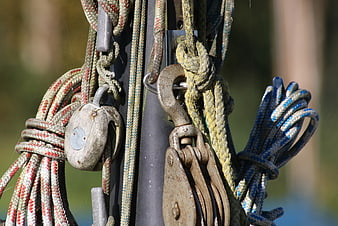 Close-up of weathered sailing ropes and pulleys on a mast