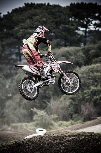 Motocross Rider Jumping Dirt Bike on Off-Road Track