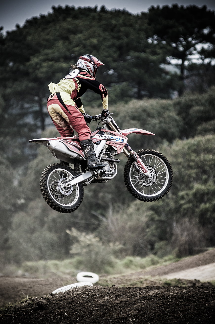 Motocross Rider Jumping Dirt Bike on Off-Road Track