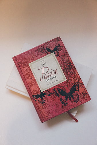 Red Journal with Butterfly Design on White Background