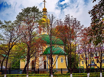 Yellow Orthodox Church with Golden Dome in Autumn Park
