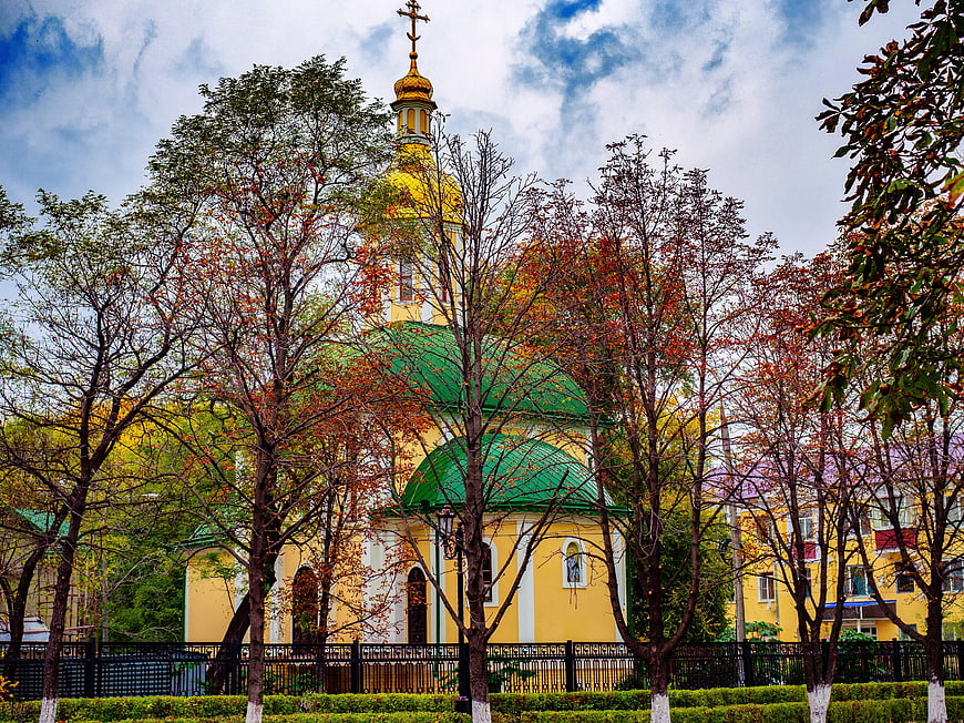 Yellow Orthodox Church with Golden Dome in Autumn Park