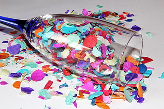 Spilled Multicolored Confetti in Blue Champagne Glass