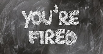 You're Fired Chalk Text On Blackboard