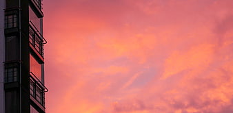 Modern Building Silhouette Against Vibrant Pink Sunset Sky