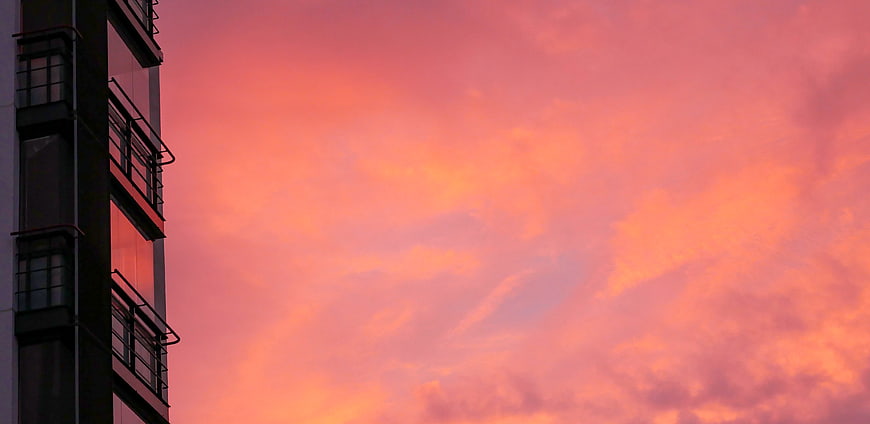 Modern Building Silhouette Against Vibrant Pink Sunset Sky