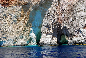 Turquoise sea cave in white limestone cliffs