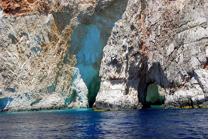 Turquoise sea cave in white limestone cliffs