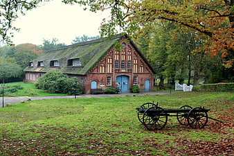 Historic Thatched Roof Farmhouse in Autumn Landscape