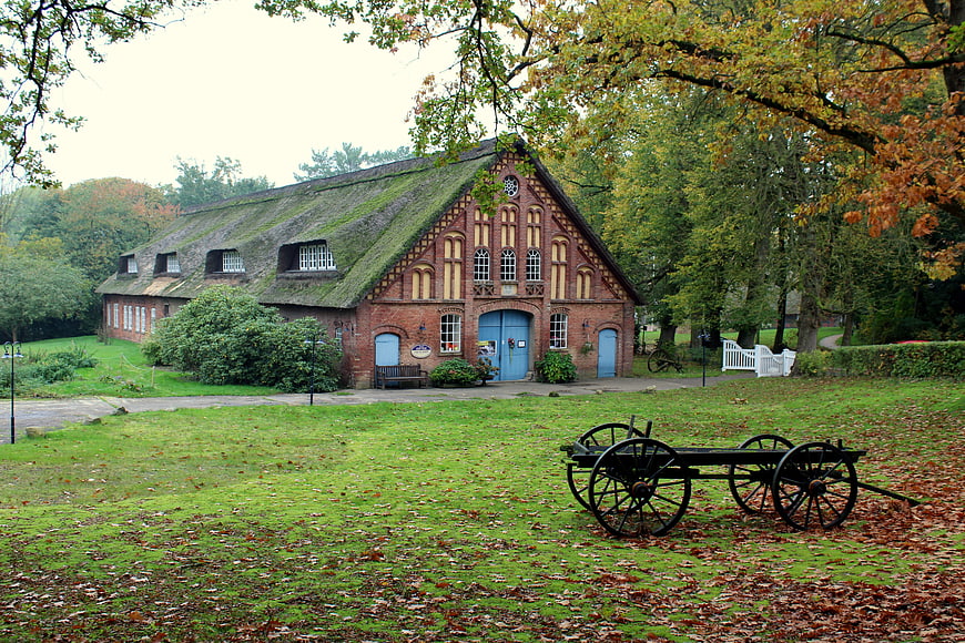 Historic Thatched Roof Farmhouse in Autumn Landscape