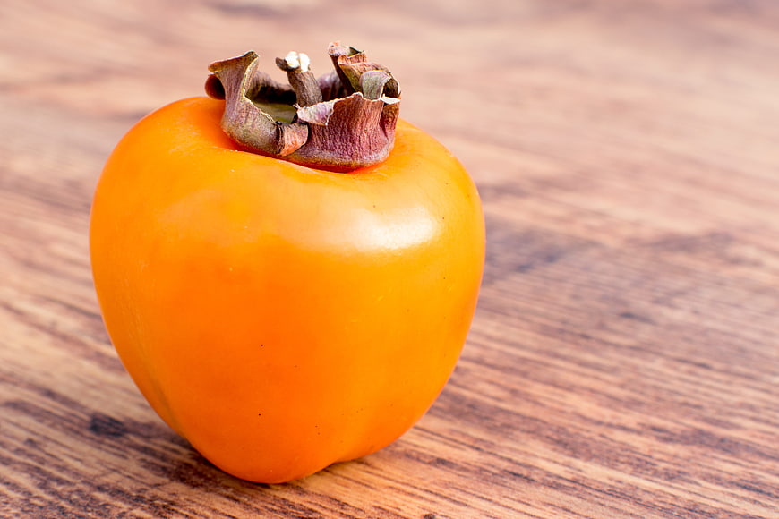 Ripe Orange Persimmon Fruit On Rustic Wooden Table